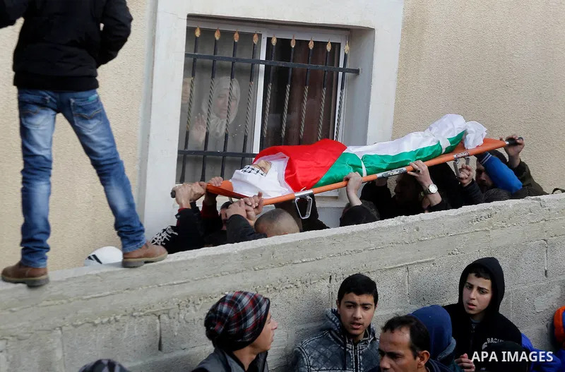 Mourners carry the body of Palestinian Haitham Al-Bau, who was shot and killed by Israeli soldiers, during his funeral, in the West Bank city of Hebron February 6, 2016. Israeli soldiers shot and killed Al-Bao, 17, in th...