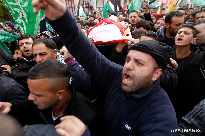 Mourners carry the body of Palestinian Haitham Al-Bau, who was shot and killed by Israeli soldiers, during his funeral, in the West Bank city of Hebron February 6, 2016. Israeli soldiers shot and killed Al-Bao, 17, in th...