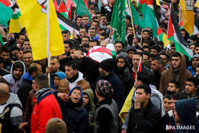 Mourners carry the body of Palestinian Haitham Al-Bau, who was shot and killed by Israeli soldiers, during his funeral, in the West Bank city of Hebron February 6, 2016. Israeli soldiers shot and killed Al-Bao, 17, in th...