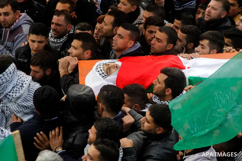 Mourners carry the body of Palestinian Haitham Al-Bau, who was shot and killed by Israeli soldiers, during his funeral, in the West Bank city of Hebron February 6, 2016. Israeli soldiers shot and killed Al-Bao, 17, in th...