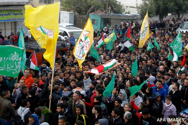 Mourners carry the body of Palestinian Haitham Al-Bau, who was shot and killed by Israeli soldiers, during his funeral, in the West Bank city of Hebron February 6, 2016. Israeli soldiers shot and killed Al-Bao, 17, in th...