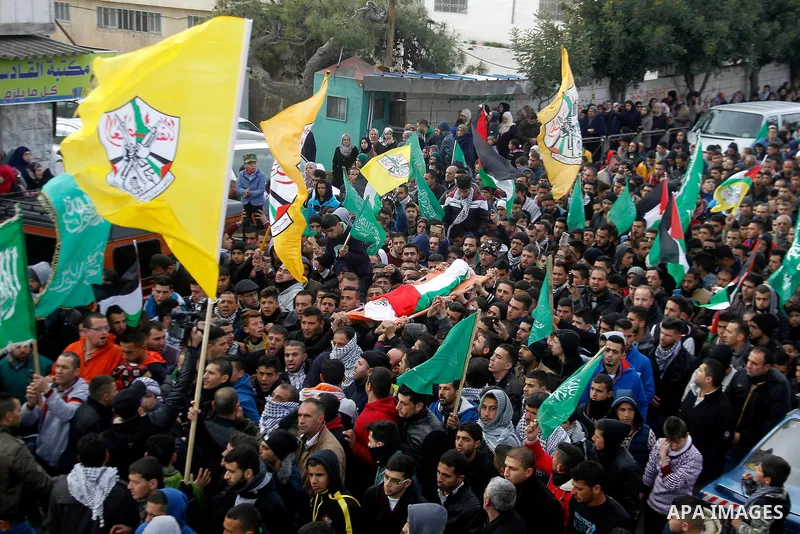 Mourners carry the body of Palestinian Haitham Al-Bau, who was shot and killed by Israeli soldiers, during his funeral, in the West Bank city of Hebron February 6, 2016. Israeli soldiers shot and killed Al-Bao, 17, in th...