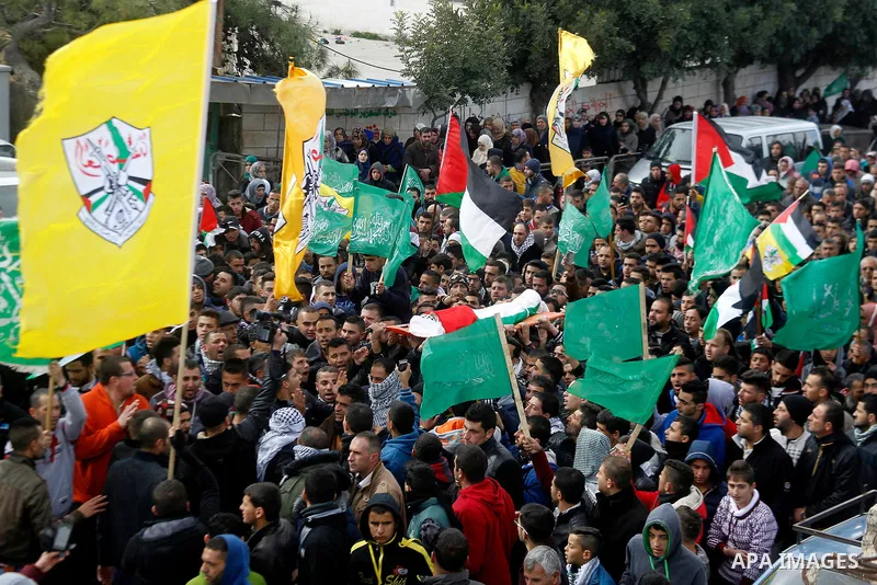Mourners carry the body of Palestinian Haitham Al-Bau, who was shot and killed by Israeli soldiers, during his funeral, in the West Bank city of Hebron February 6, 2016. Israeli soldiers shot and killed Al-Bao, 17, in th...