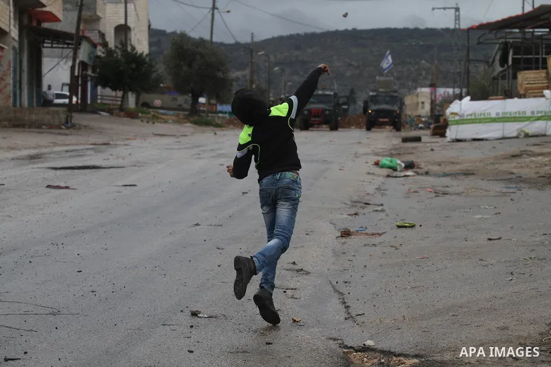 A Palestinian protester prepares his sling to hurl stones towards Israeli troops during clashes in the West Bank town of Qabatya, near Jenin February 6, 2016. On Wednesday, three young Palestinian men from Qabatya wieldi...