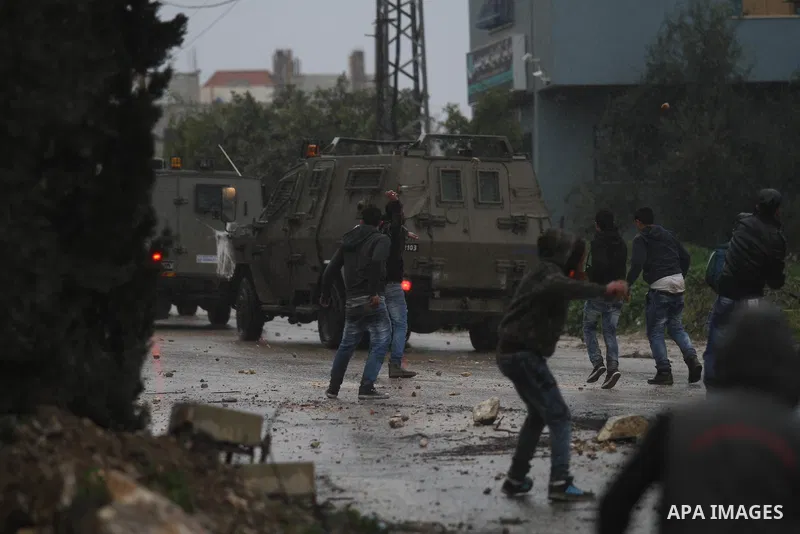 A Palestinian protester prepares his sling to hurl stones towards Israeli troops during clashes in the West Bank town of Qabatya, near Jenin February 6, 2016. On Wednesday, three young Palestinian men from Qabatya wieldi...