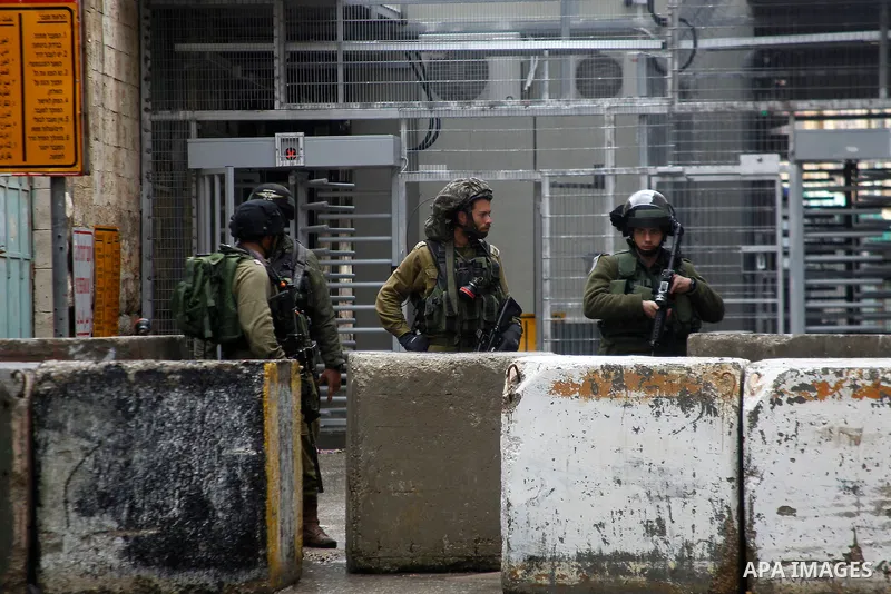 Israeli security forces stand guard during a protest demanding to end the occupation and against settlement in the West Bank city of Hebron, on Feb. 08, 2016. Photo by Wisam Hashlamoun