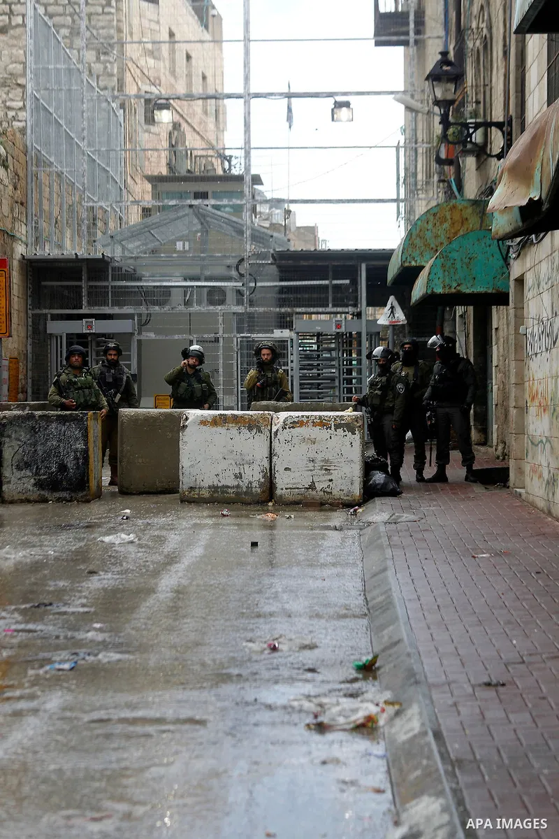 Israeli security forces stand guard during a protest demanding to end the occupation and against settlement in the West Bank city of Hebron, on Feb. 08, 2016. Photo by Wisam Hashlamoun