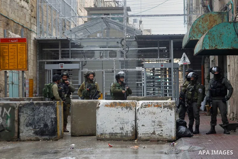 Israeli security forces stand guard during a protest demanding to end the occupation and against settlement in the West Bank city of Hebron, on Feb. 08, 2016. Photo by Wisam Hashlamoun