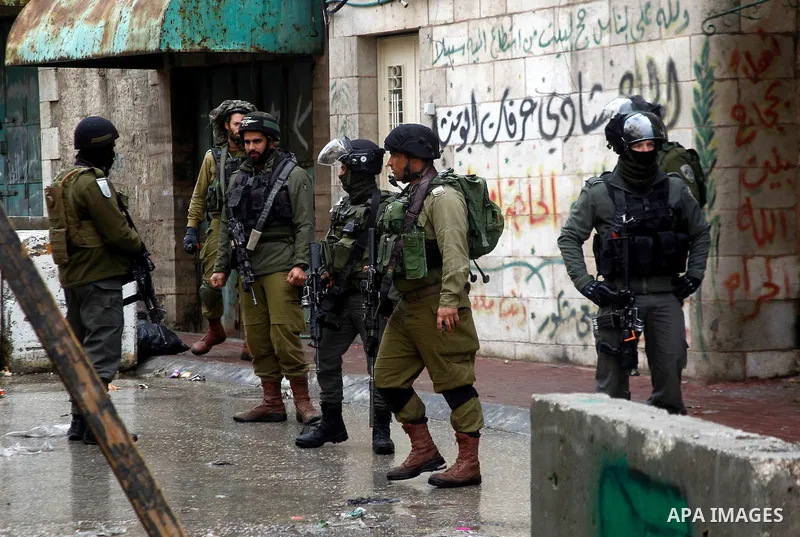 Israeli security forces stand guard during a protest demanding to end the occupation and against settlement in the West Bank city of Hebron, on Feb. 08, 2016. Photo by Wisam Hashlamoun