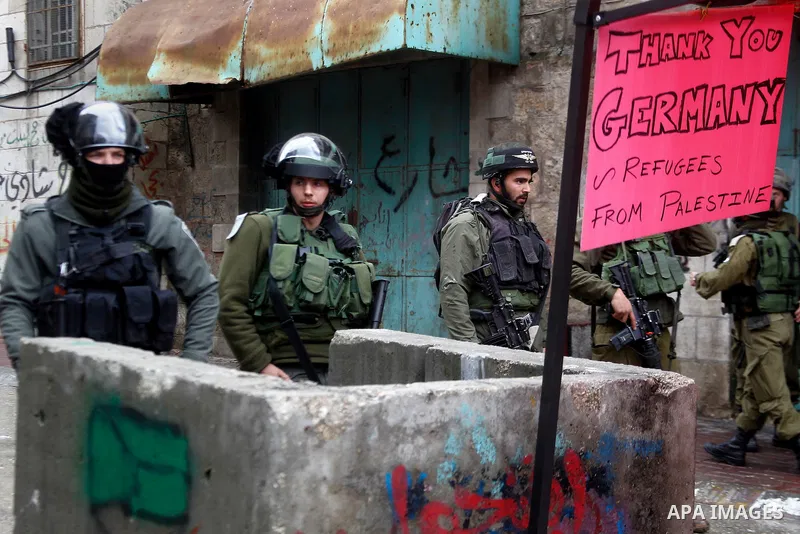 Israeli security forces stand guard during a protest demanding to end the occupation and against settlement in the West Bank city of Hebron, on Feb. 08, 2016. Photo by Wisam Hashlamoun