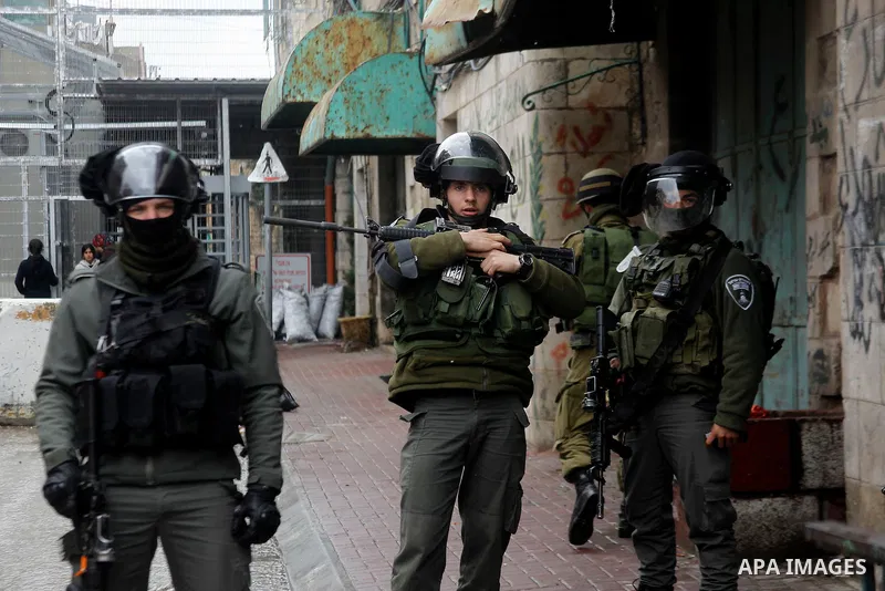 Israeli security forces stand guard during a protest demanding to end the occupation and against settlement in the West Bank city of Hebron, on Feb. 08, 2016. Photo by Wisam Hashlamoun