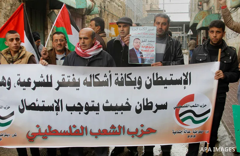 Palestinians take part during a protest demanding to end the occupation and against settlement in the West Bank city of Hebron, on Feb. 08, 2016. Photo by Wisam Hashlamoun