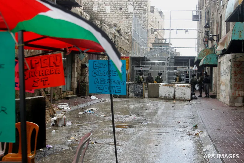 Israeli security forces stand guard during a protest demanding to end the occupation and against settlement in the West Bank city of Hebron, on Feb. 08, 2016. Photo by Wisam Hashlamoun