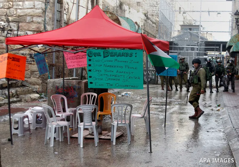 Israeli security forces stand guard during a protest demanding to end the occupation and against settlement in the West Bank city of Hebron, on Feb. 08, 2016. Photo by Wisam Hashlamoun
