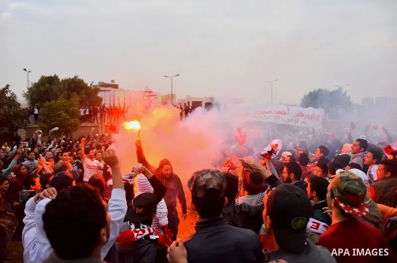 Al-Zamalek soccer club fans known as 'Ultras White Knights" light flares and shout slogans to mark the first anniversary of killing al-Zamalek fans in Cairo, Egypt, Feb. 08, 2016. At least 22 soccer fans were crushed to...