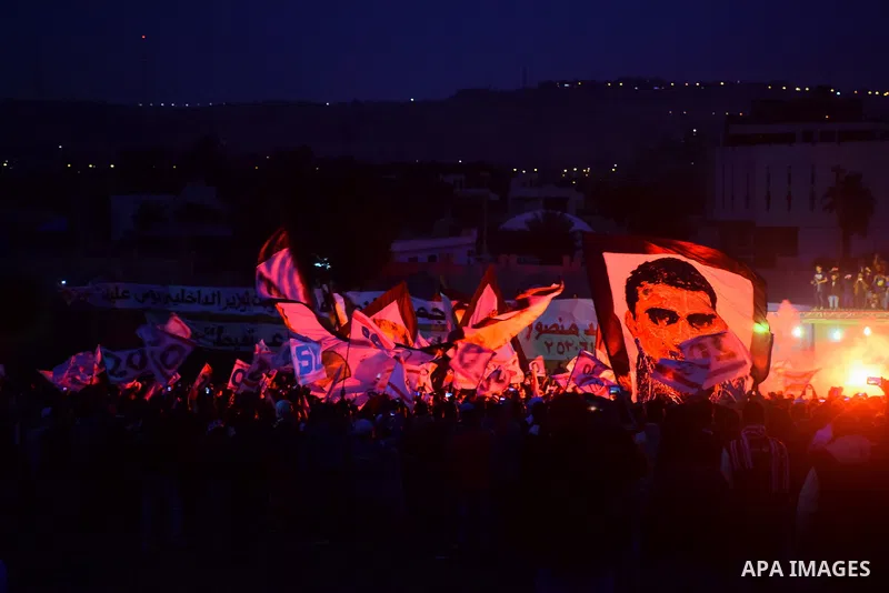 Al-Zamalek soccer club fans known as 'Ultras White Knights" light flares and shout slogans to mark the first anniversary of killing al-Zamalek fans in Cairo, Egypt, Feb. 08, 2016. At least 22 soccer fans were crushed to...
