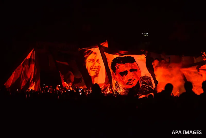 Al-Zamalek soccer club fans known as 'Ultras White Knights" light flares and shout slogans to mark the first anniversary of killing al-Zamalek fans in Cairo, Egypt, Feb. 08, 2016. At least 22 soccer fans were crushed to...