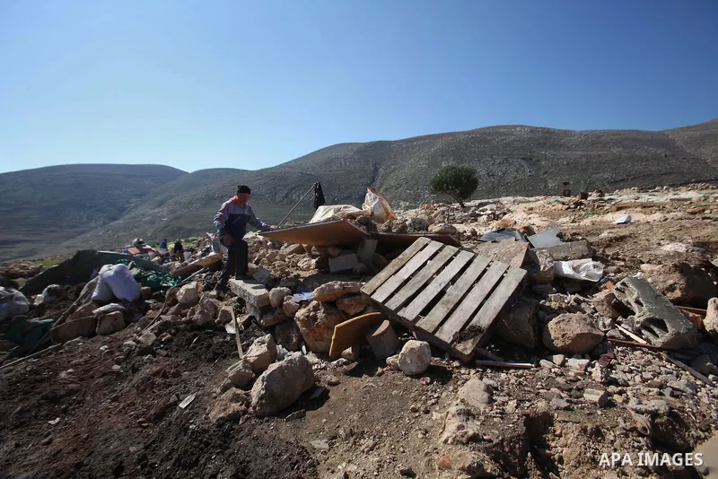 Palestinians inspect the rubble of a house that was demolished after Israeli authorities said it was built without a permit at Kherbet Tana, eastern the West Bank city of Nablus, on February 9, 2016. Photo by Nedal Eshta...