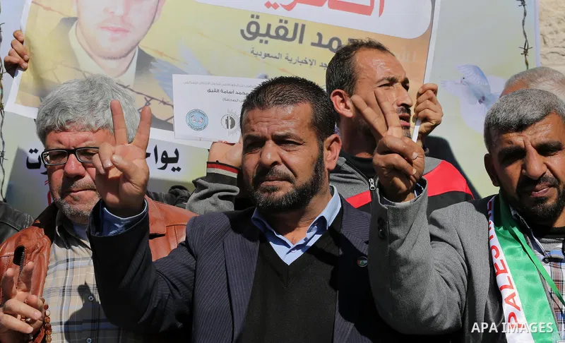 Palestinians hold posters during a demonstration in support of hunger striking Palestinian journalist Mohammed al-Qiq, in front of Red cross office in Gaza city on February 9, 2016. The 33-year-old television reporter wi...