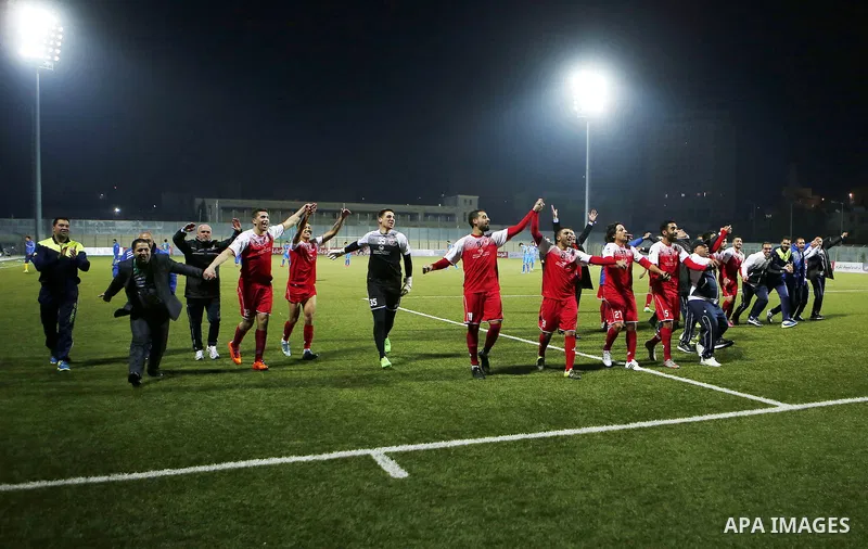 Ahly Al-Khalil football club's players celebrate after a football match crucial AFC Champions League Playoff phase with FC Khujand club's at Dura Stadium in the West Bank city of Hebron on Feb. 09, 2016. Mahmoud Wadi cla...