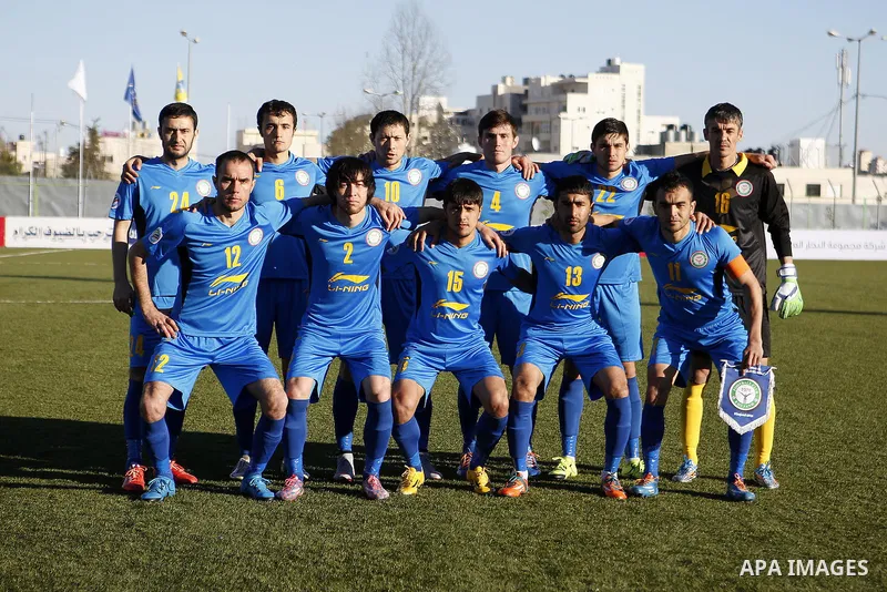 FC Khujand club's players pose for a group picture before their match with Ahly Al-Khalil football club's during the football match crucial AFC Champions League Playoff phase at Dura Stadium in the West Bank city of Hebr...