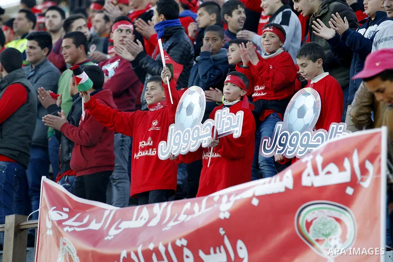 Fans attend the crucial AFC Champions League Playoff phase football match between Palestinian's Ahly Al-Khalil football team and FC Khujand team at Dura Stadium in the West Bank city of Hebron on Feb. 09, 2016. Mahmoud W...