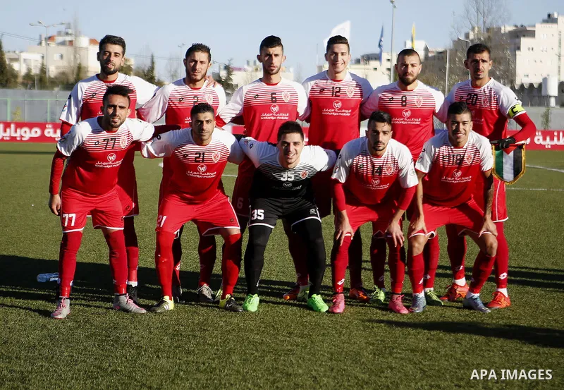 Ahly Al-Khalil football club's players pose for a group picture before their match with FC Khujand during the football match crucial AFC Champions League Playoff phase at Dura Stadium in the West Bank city of Hebron on F...