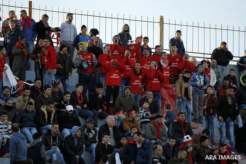 Fans attend the crucial AFC Champions League Playoff phase football match between Palestinian's Ahly Al-Khalil football team and FC Khujand team at Dura Stadium in the West Bank city of Hebron on Feb. 09, 2016. Mahmoud W...