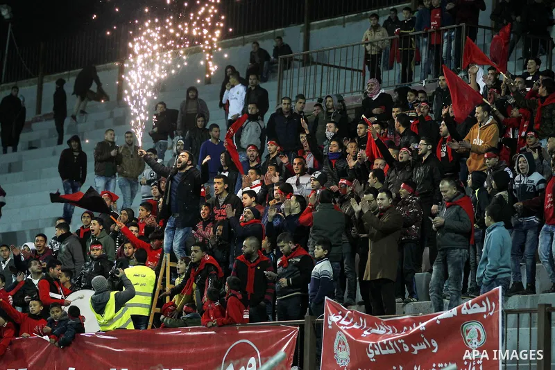 Fans attend the crucial AFC Champions League Playoff phase football match between Palestinian's Ahly Al-Khalil football team and FC Khujand team at Dura Stadium in the West Bank city of Hebron on Feb. 09, 2016. Mahmoud W...