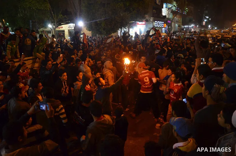 Fans of Al Ahly football club celebrate after their Egyptian Premier League derby soccer match against El Zamalek at Borg El Arab "Army Stadium" near Alexandria, Egypt, February 9, 2016. Photo by Amr Sayed