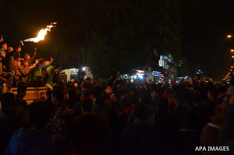 Fans of Al Ahly football club celebrate after their Egyptian Premier League derby soccer match against El Zamalek at Borg El Arab "Army Stadium" near Alexandria, Egypt, February 9, 2016. Photo by Amr Sayed
