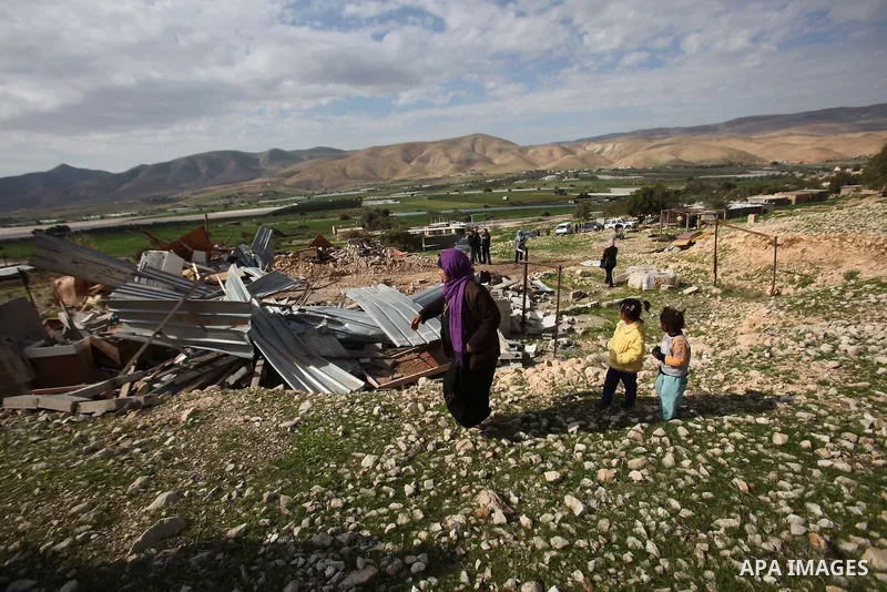 Palestinians collect belongings near the rubble of their house that were demolished by the Israeli army, in the village of El-Jiftlik north the west bank city of jericho, on February 10, 2016. The owners of the house sai...