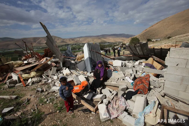 Palestinians collect belongings near the rubble of their house that were demolished by the Israeli army, in the village of El-Jiftlik north the west bank city of jericho, on February 10, 2016. The owners of the house sai...