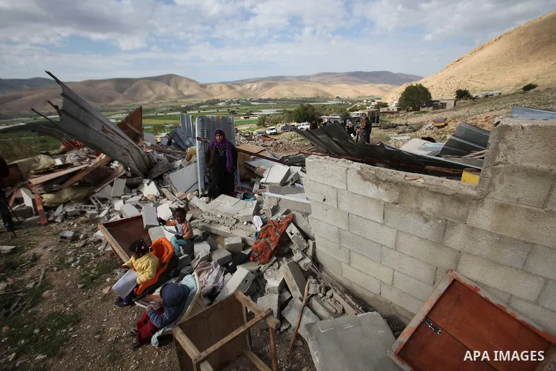 Palestinians collect belongings near the rubble of their house that were demolished by the Israeli army, in the village of El-Jiftlik north the west bank city of jericho, on February 10, 2016. The owners of the house sai...