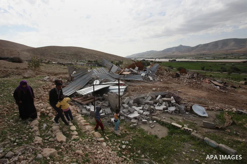Palestinians collect belongings near the rubble of their house that were demolished by the Israeli army, in the village of El-Jiftlik north the west bank city of jericho, on February 10, 2016. The owners of the house sai...