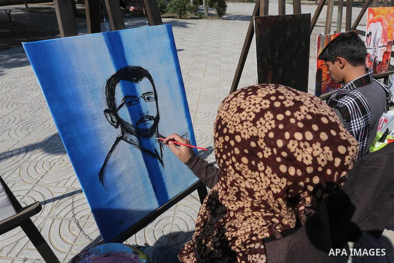 Palestinian artists paint artwork during a protest in support of hunger striking Palestinian journalist Mohammed al-Qiq, in in Gaza city on February 10, 2016. The 33-year-old television reporter will keep up his 10-week...