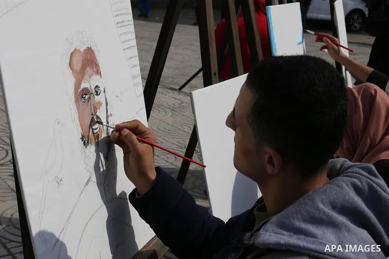 Palestinian artists paint artwork during a protest in support of hunger striking Palestinian journalist Mohammed al-Qiq, in in Gaza city on February 10, 2016. The 33-year-old television reporter will keep up his 10-week...