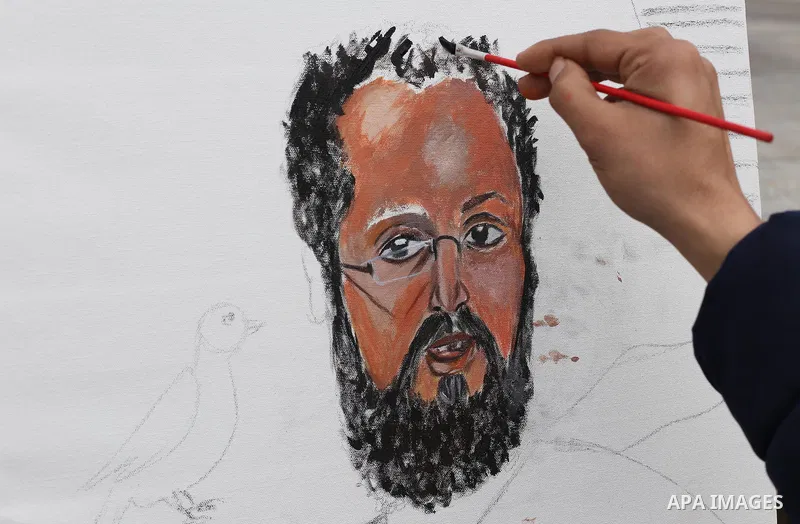 Palestinian artists paint artwork during a protest in support of hunger striking Palestinian journalist Mohammed al-Qiq, in in Gaza city on February 10, 2016. The 33-year-old television reporter will keep up his 10-week...