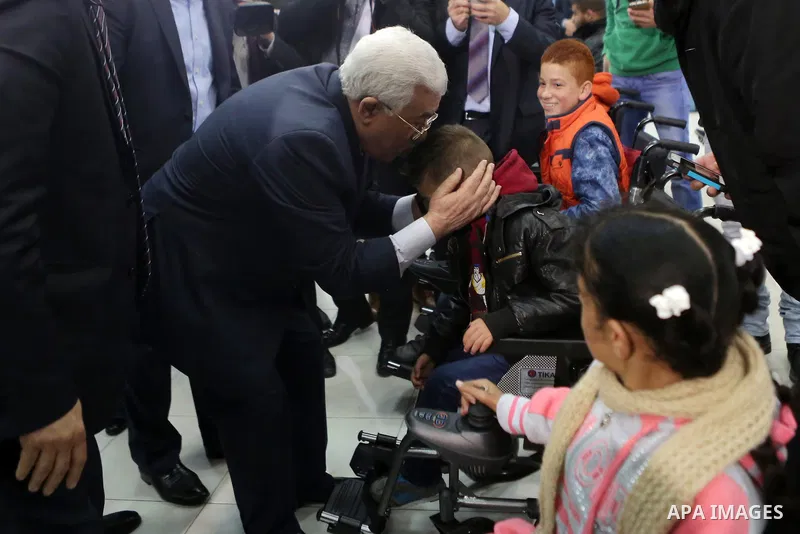 Palestinian President, Mahmoud abbas, attends the ceremony of the distribution of an electric wheelchairs for the Palestinians disabled, in thw West Bank city of Ramallah, on feb. 10, 2016. Photo by Shadi Hatem