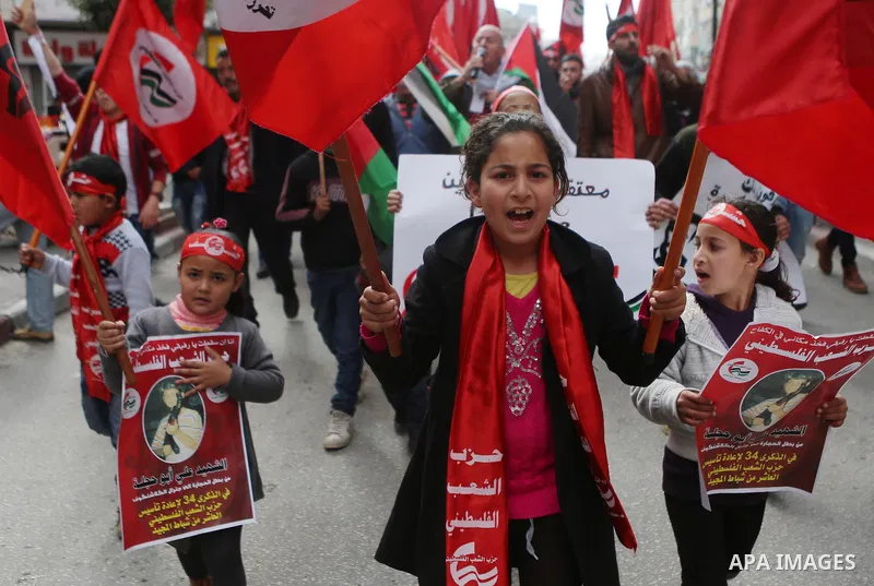 Palestinians hold posters during a protest in support of hunger striking Palestinian journalist Mohammed al-Qiq, in the West Bank city of Ramallah on February 11, 2016. The 33-year-old television reporter will keep up hi...