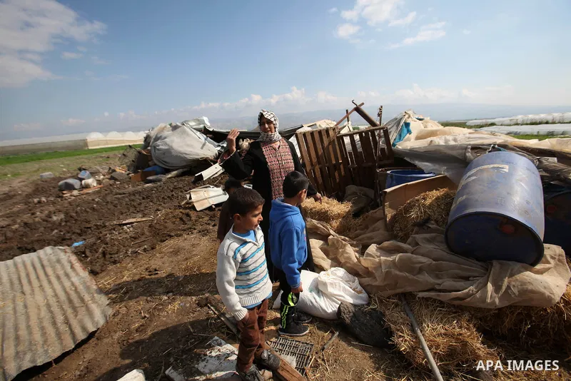 Palestinians collect belongings near the rubble of their house that were demolished by the Israeli army, in the Jordan valley, near the West Bank town of Tubas on February 11, 2016. Israel is planning to annex the Jordan...