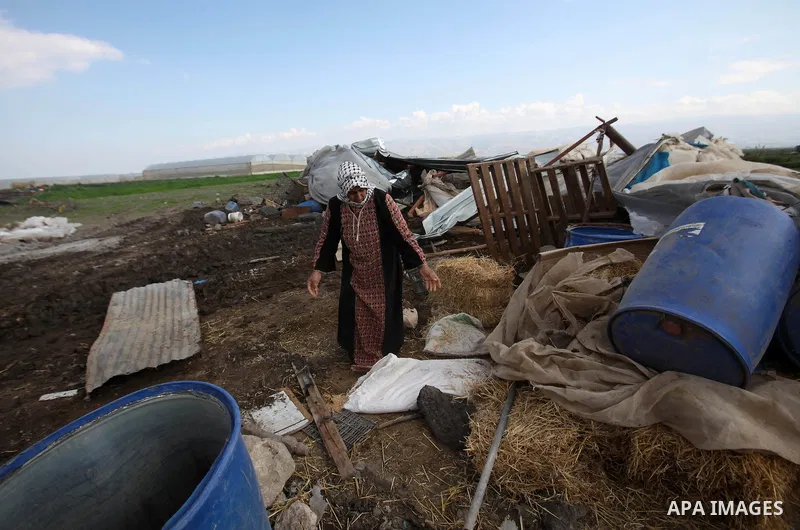 Palestinians collect belongings near the rubble of their house that were demolished by the Israeli army, in the Jordan valley, near the West Bank town of Tubas on February 11, 2016. Israel is planning to annex the Jordan...