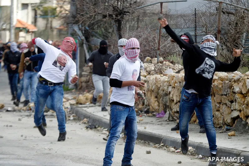 Palestinian protesters clash with Israeli security forces following the funeral of Omar Jawabra, who was killed by Israeli fire during clashes near hebron the day before, at al-Aroub Palestinian refugee camp, north the W...