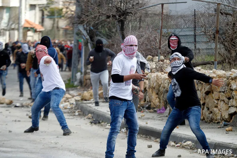 Palestinian protesters clash with Israeli security forces following the funeral of Omar Jawabra, who was killed by Israeli fire during clashes near hebron the day before, at al-Aroub Palestinian refugee camp, north the W...