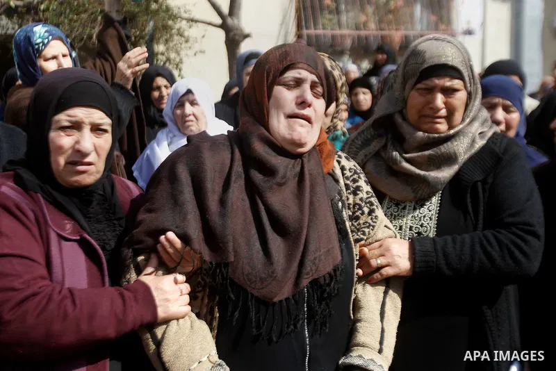 The mother (C) of Palestinian youth Omar Jawabra, who was killed by Israeli fire during clashes near hebron the day before, mourns during his funeral at al-Aroub Palestinian refugee camp, north the West Bank city of Hebr...