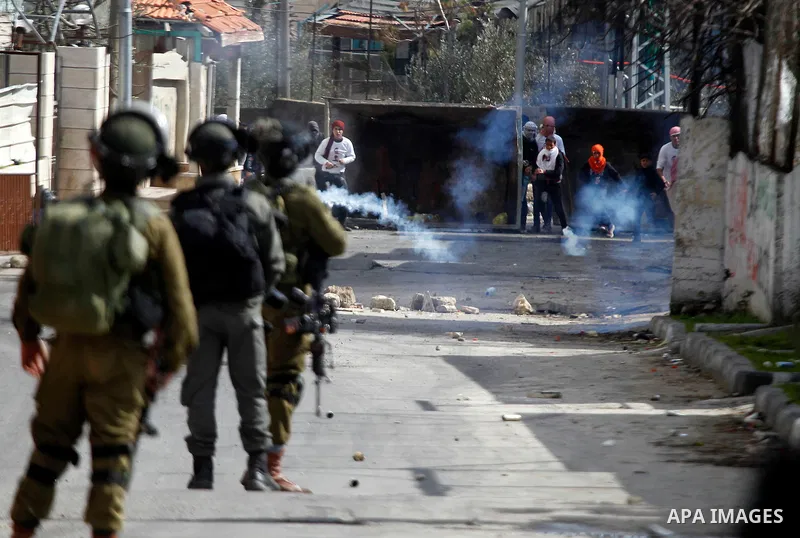 Palestinian protesters clash with Israeli security forces following the funeral of Omar Jawabra, who was killed by Israeli fire during clashes near hebron the day before, at al-Aroub Palestinian refugee camp, north the W...