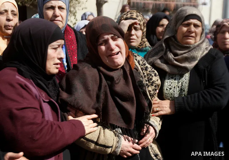 The mother (C) of Palestinian youth Omar Jawabra, who was killed by Israeli fire during clashes near hebron the day before, mourns during his funeral at al-Aroub Palestinian refugee camp, north the West Bank city of Hebr...