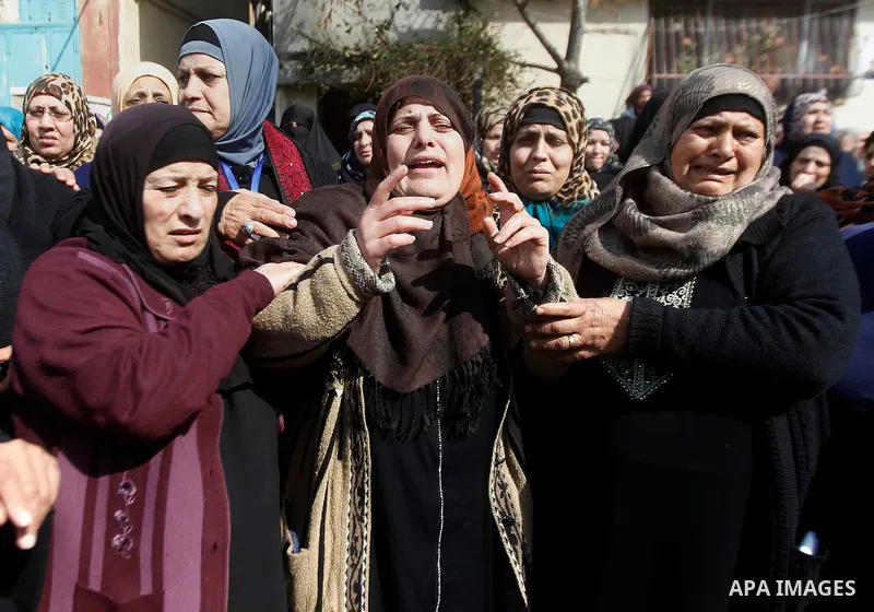 The mother (C) of Palestinian youth Omar Jawabra, who was killed by Israeli fire during clashes near hebron the day before, mourns during his funeral at al-Aroub Palestinian refugee camp, north the West Bank city of Hebr...