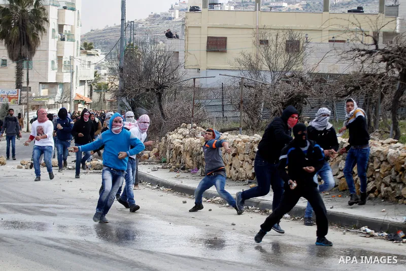 Palestinian protesters clash with Israeli security forces following the funeral of Omar Jawabra, who was killed by Israeli fire during clashes near hebron the day before, at al-Aroub Palestinian refugee camp, north the W...