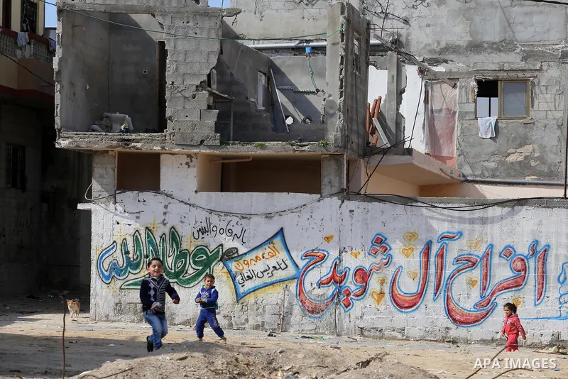 Palestinian children play in front of the remains of a house, destroyed during 2014 war, in Shijaiyah neighborhood in the east of Gaza city on Feb. 11, 2016. Rebuilding of Palestinian houses which destroyed during 2014 w...